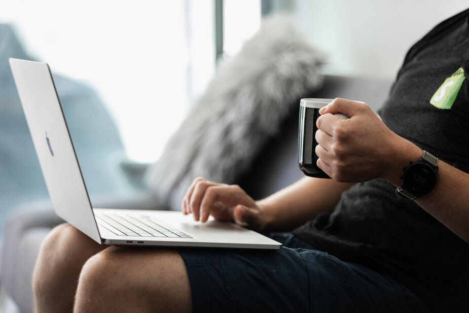 coffee-in-hand-working-on-the-couch-close-up.jpg